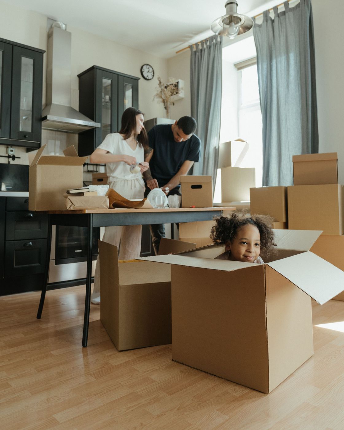 Family unpacking boxes in their new home